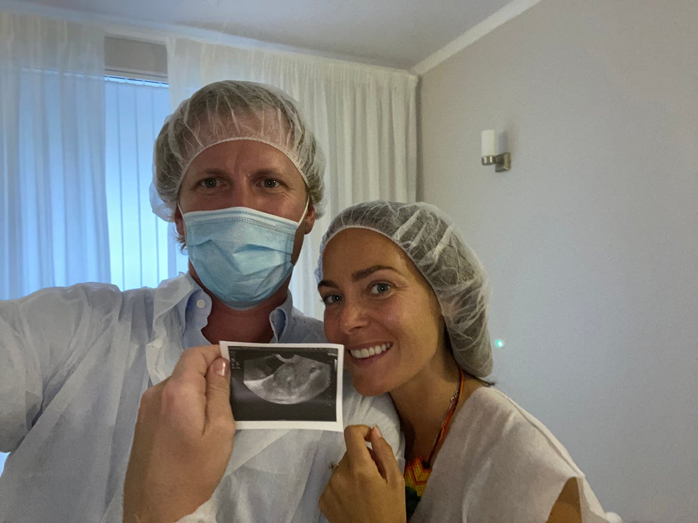 Anna and her husband with their first scan of Lev (PA Real Life/Collect)