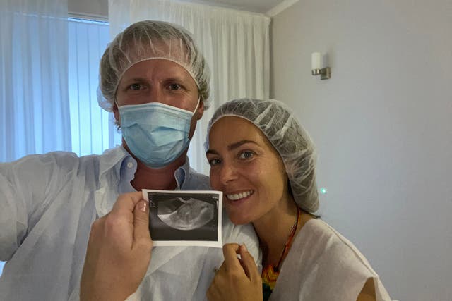 Anna and her husband with their first scan of Lev (PA Real Life/Collect)