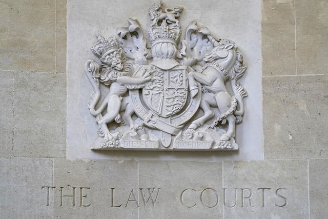 A stone carving of the royal coat of arms above a sign for The Law Courts outside the entrance to Bristol Crown court, where eight teenagers are on trial following the death of 16-year-old Ramarni Crosby last year (Andrew Matthews/PA)