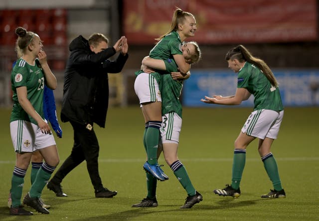 <p>Emily Wilson and Emma McMaster of Northern Ireland celebrate victory over Ukraine in April 2021 </p>