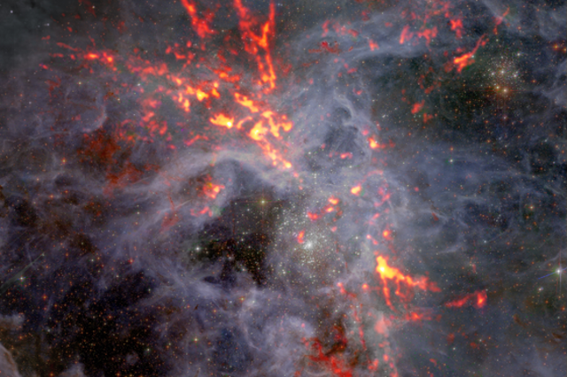 <p>The large, star forming region known as 30 Doradus sits at the heart of the Tarantula Nebular some 170,000 light years from Earth in the large Magellanic cloud. </p>