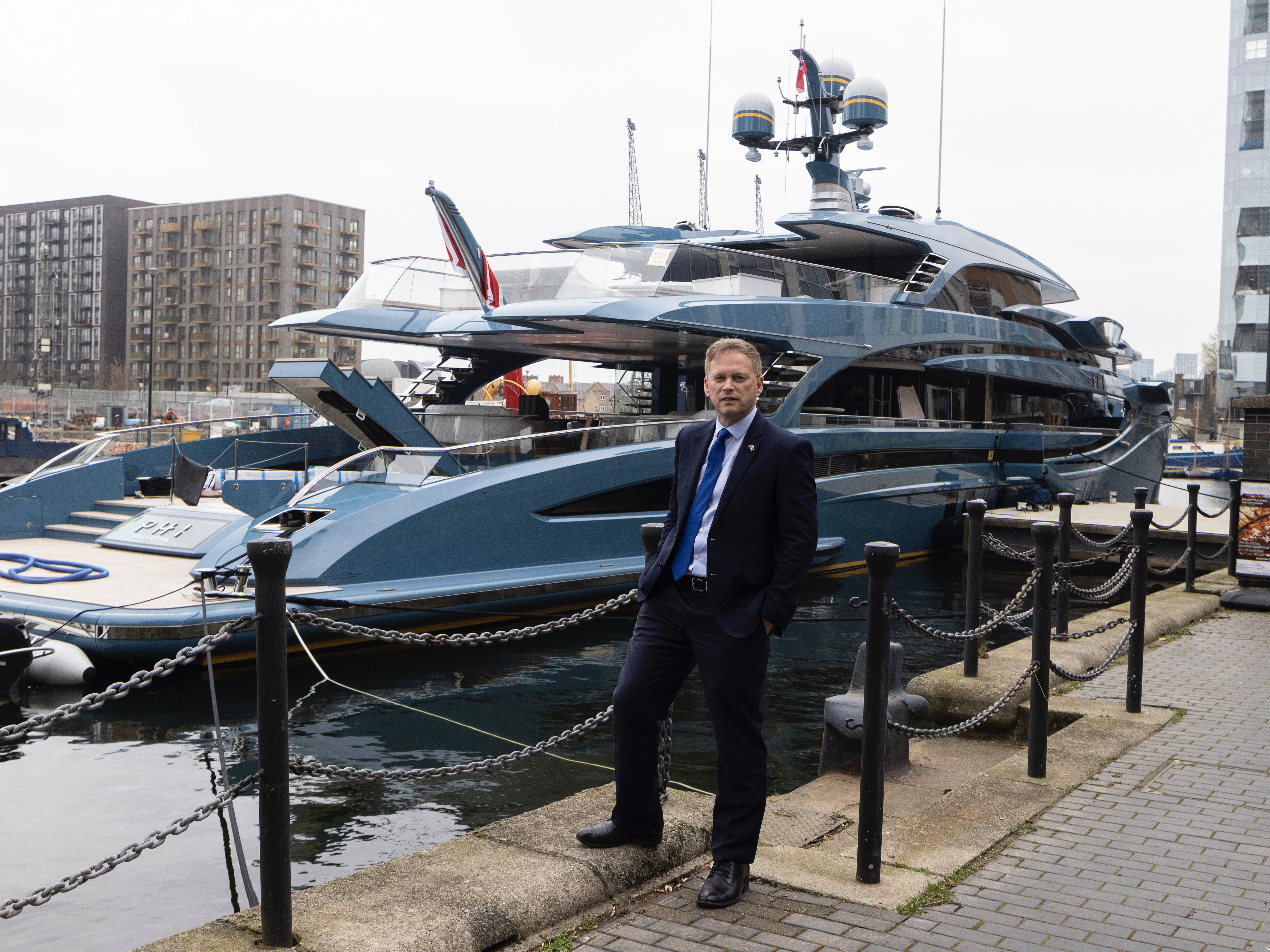 Transport secretary Grant Shapps posing in front of the detained superyacht Phi