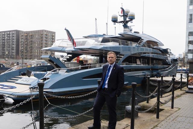 <p>Transport secretary Grant Shapps posing in front of the detained superyacht Phi </p>