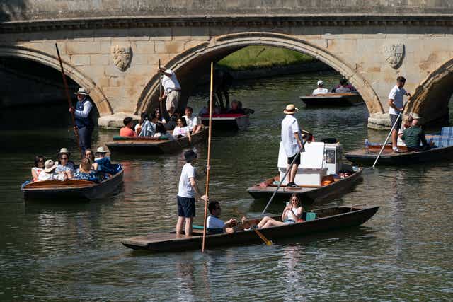 People enjoy the hot weather as they punt along the River Cam in Cambridge (PA)