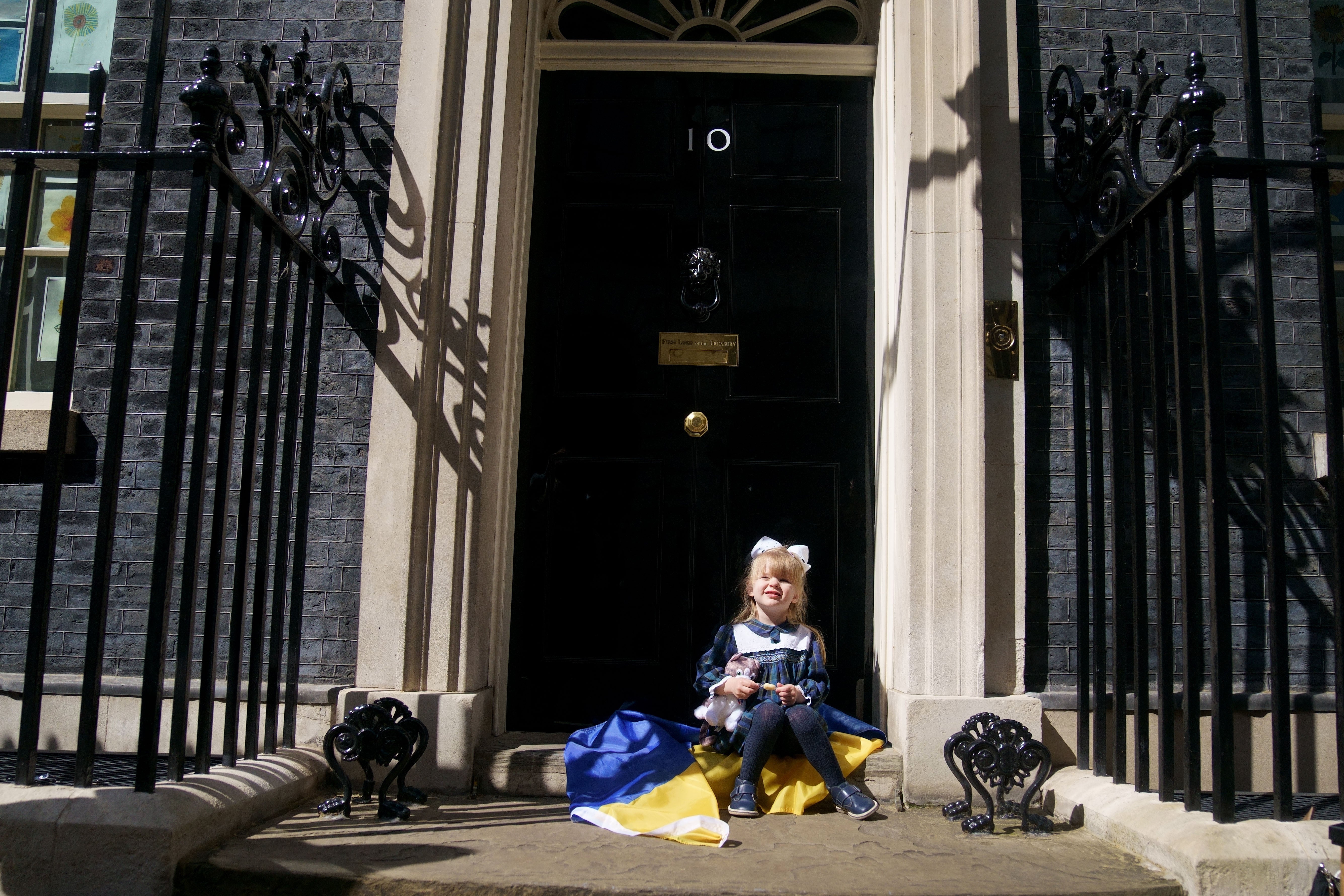 Ukrainian refugee Kira Ryndova, 3, sits on the steps of 10 Downing Street after her family met Boris Johnson last month