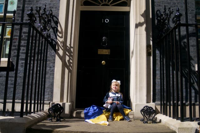 <p>Ukrainian refugee Kira Ryndova, 3, sits on the steps of 10 Downing Street after her family met Boris Johnson last month </p>