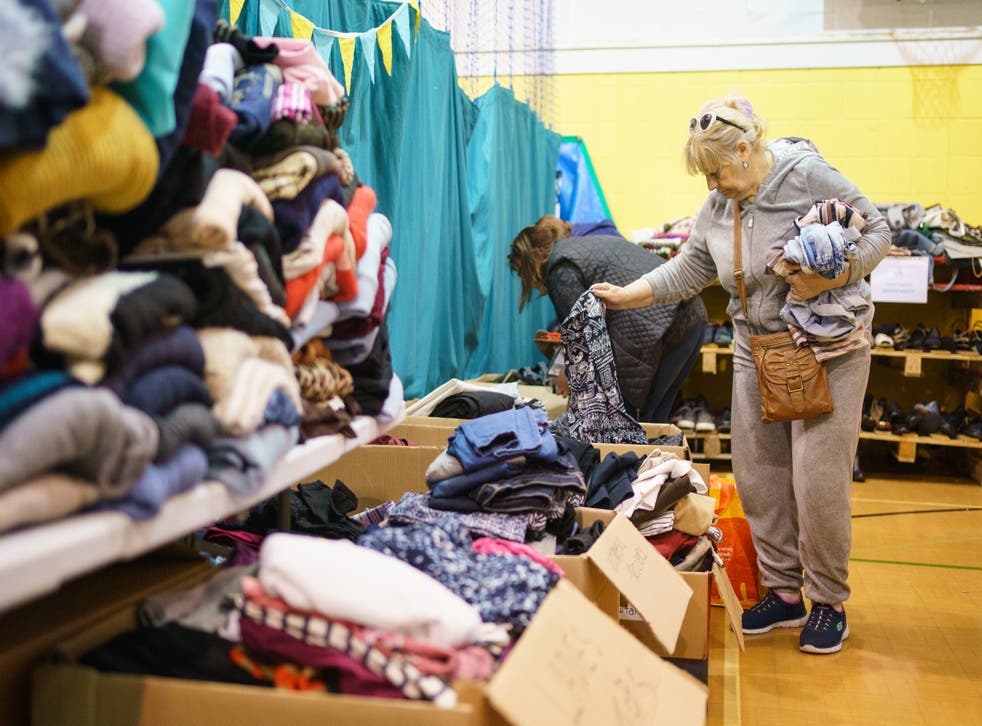 A refugee from Ukraine looks through donations collected by the Ukraine Relief Group, which organises donations for Ukrainian refugees in the UK, at the TN2 Community Centre in Tunbridge Wells, Kent (Dominic Lipinski/PA)