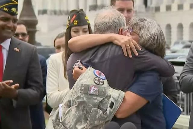 <p>Jon Stewart and Susan Zeier, mother-in-law of late Sgt First Class Heath Robinson, share an emotional moment after the bill’s passage </p>