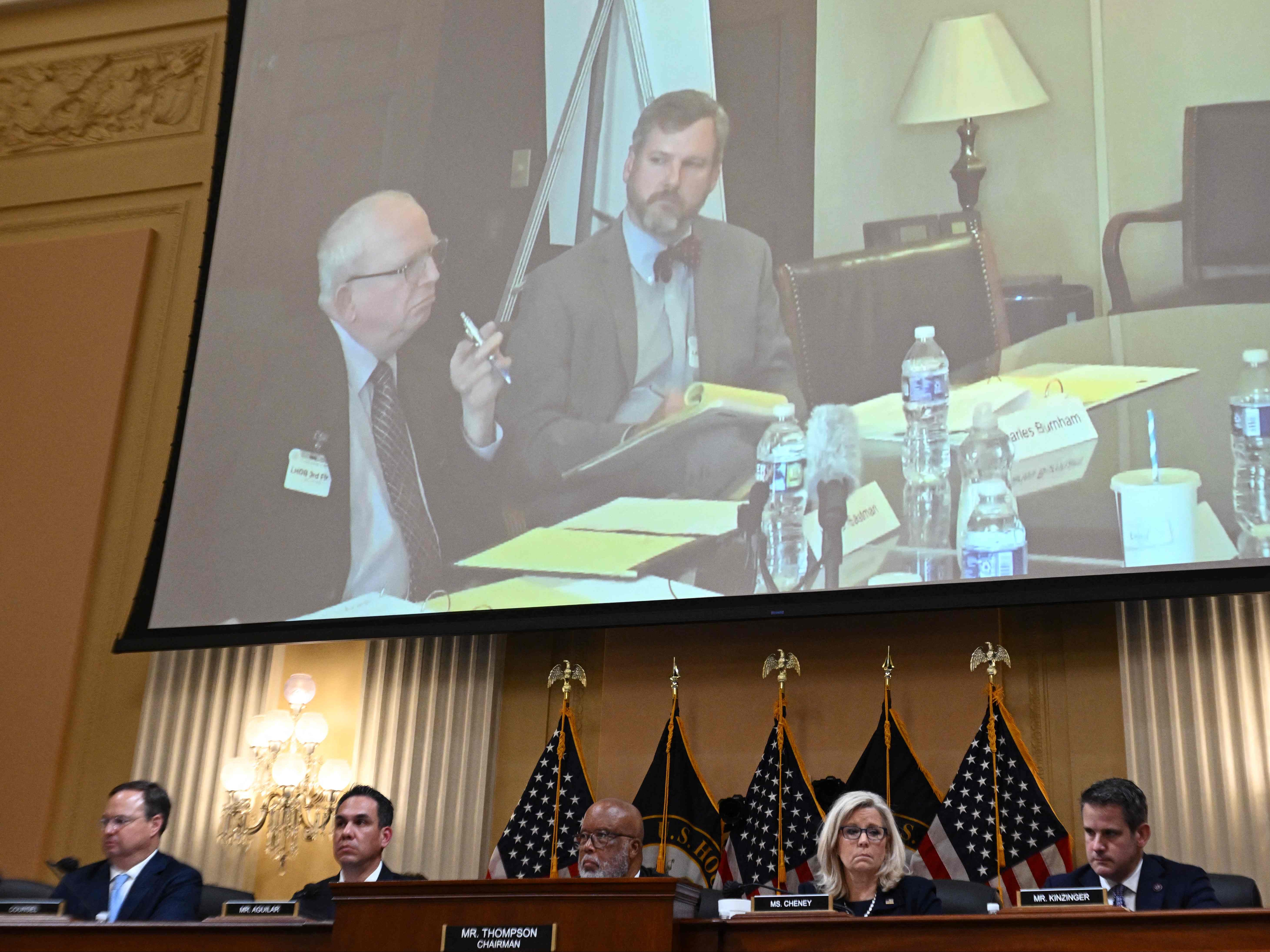 Trump lawyer John Eastman (left) is shown on a screen during a hearing of the US House Select Committee to Investigate the January 6 Attack on the US Capitol, on Capitol Hill in Washington, DC, on June 16, 2022