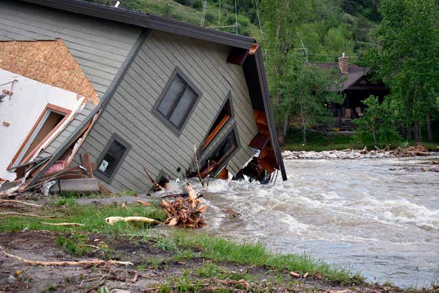 <p>A house in Red Lodge, MT that fell into the water after intense flooding hit the Yellowstone region</p>