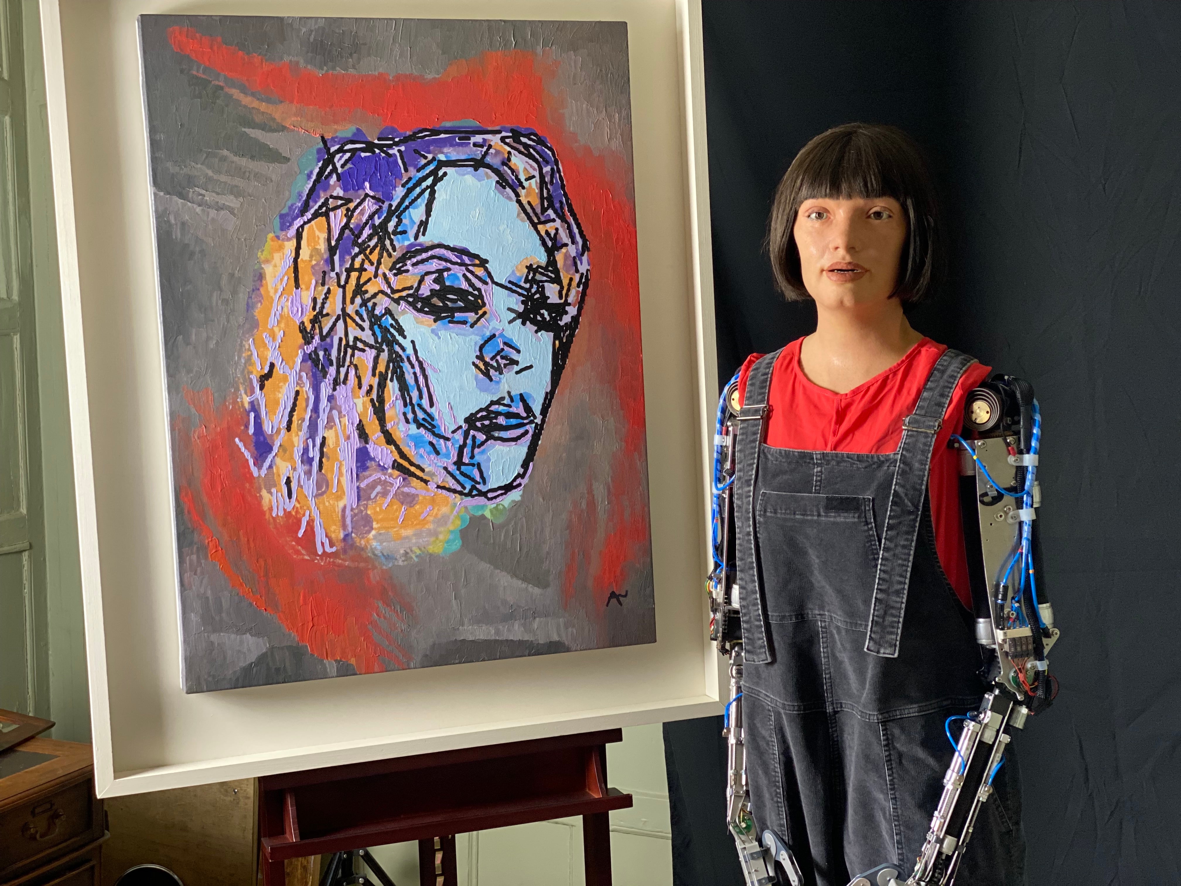 Ai-Da Robot with her portrait of Glastonbury 2022 headliner Billie Eilish (Shangri-La/PA)