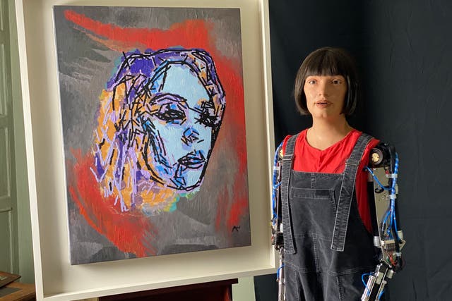Ai-Da Robot with her portrait of Glastonbury 2022 headliner Billie Eilish (Shangri-La/PA)