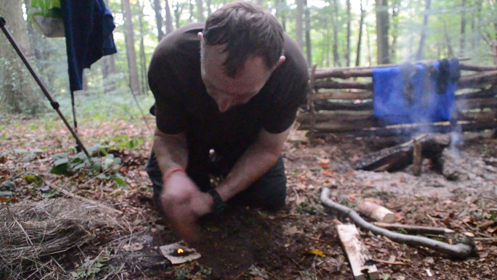 Ian making a fire (Collect/PA Real Life)