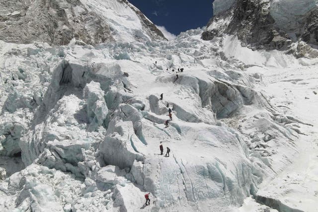 <p>Climbers cross the Khumbu icefall of Mount Everest, as seen from the Everest Base Camp, some 140 km northeast of Kathmandu in 2021 </p>