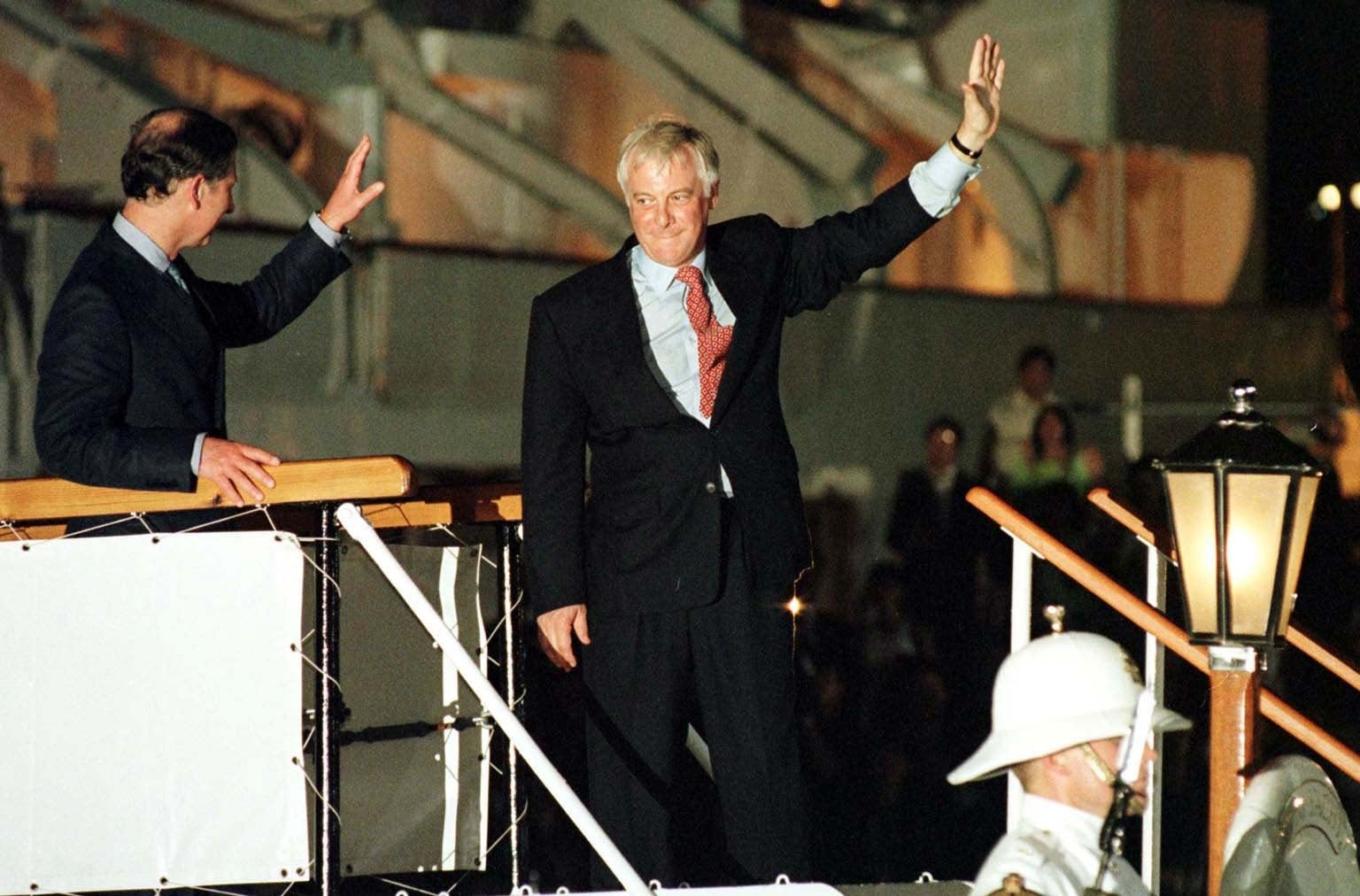 Prince Charles (left) and Chris Patten (right) wave goodbye to Hong Kong on 30 June 1997