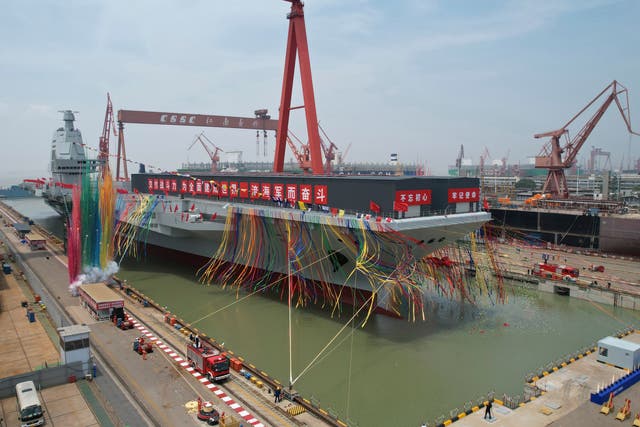 <p>Coloured smoke marks the launch ceremony for China’s third aircraft carrier christened Fujian at a dry dock in Shanghai on 17 June </p>