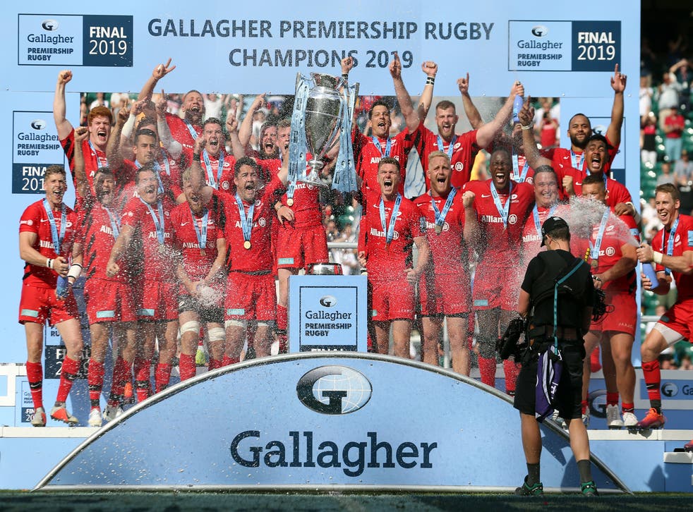 Saracens players celebrate winning the Premiership title in 2019 (PA)