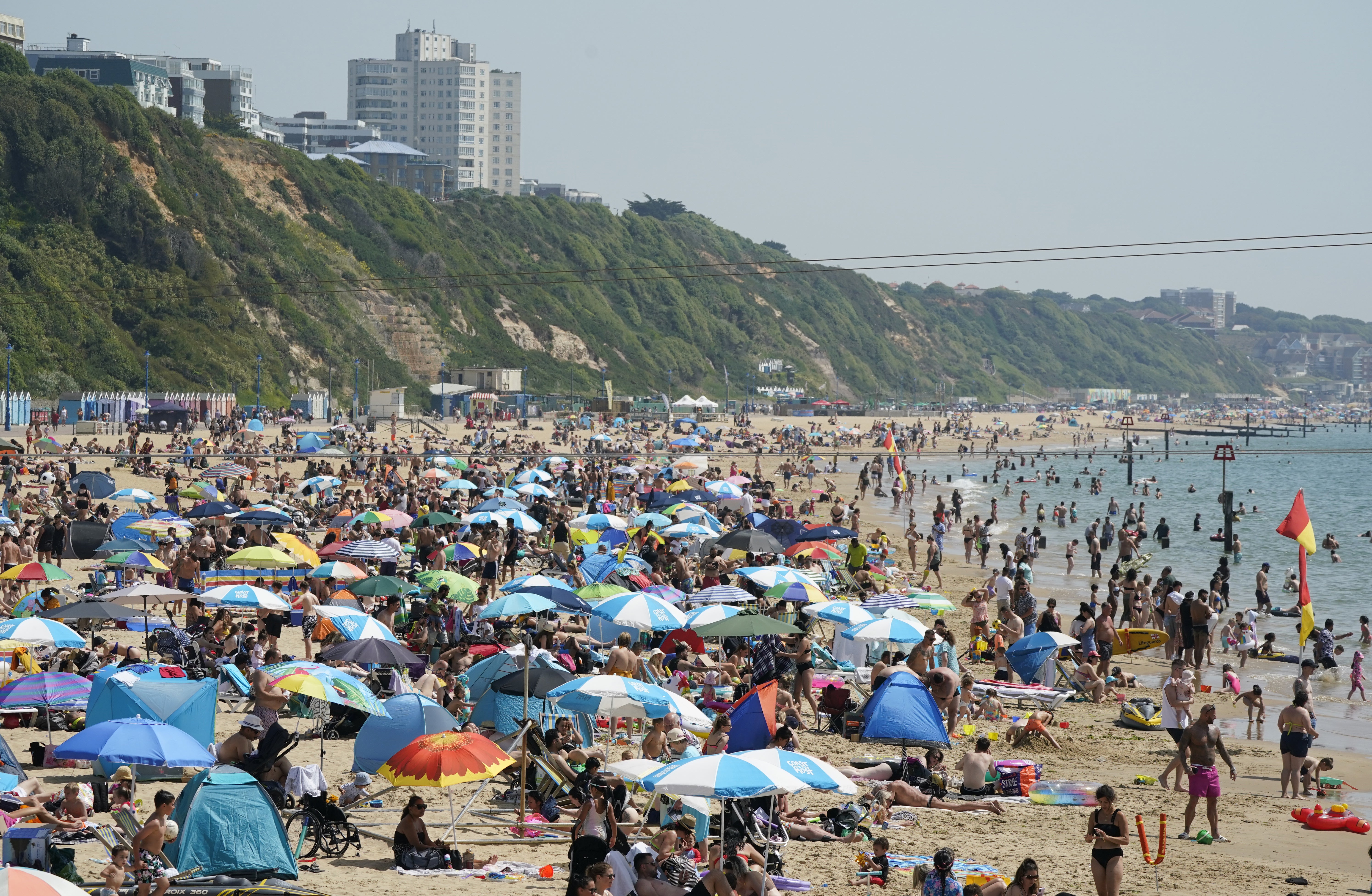 <p>People enjoy the warm weather on Bournemouth beach in Dorset</p>