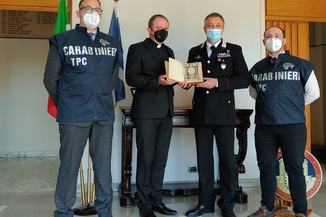 Officers from the Carabinieri returned the book to the Scots College in Rome, before it was then brought back to Scotland (Police Scotland/PA)