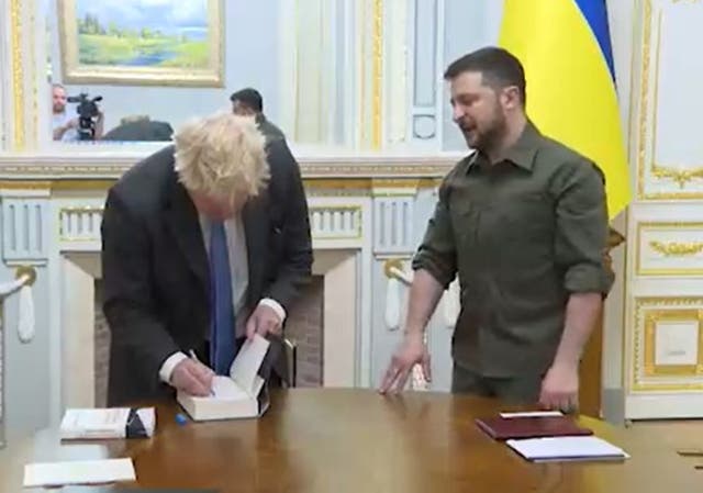 Boris Johnson gave Volodymyr Zelensky a signed copy of Robert Hardman’s book Queen Of Our Times in Kyiv (Ukrainian Presidential Press Office/PA)