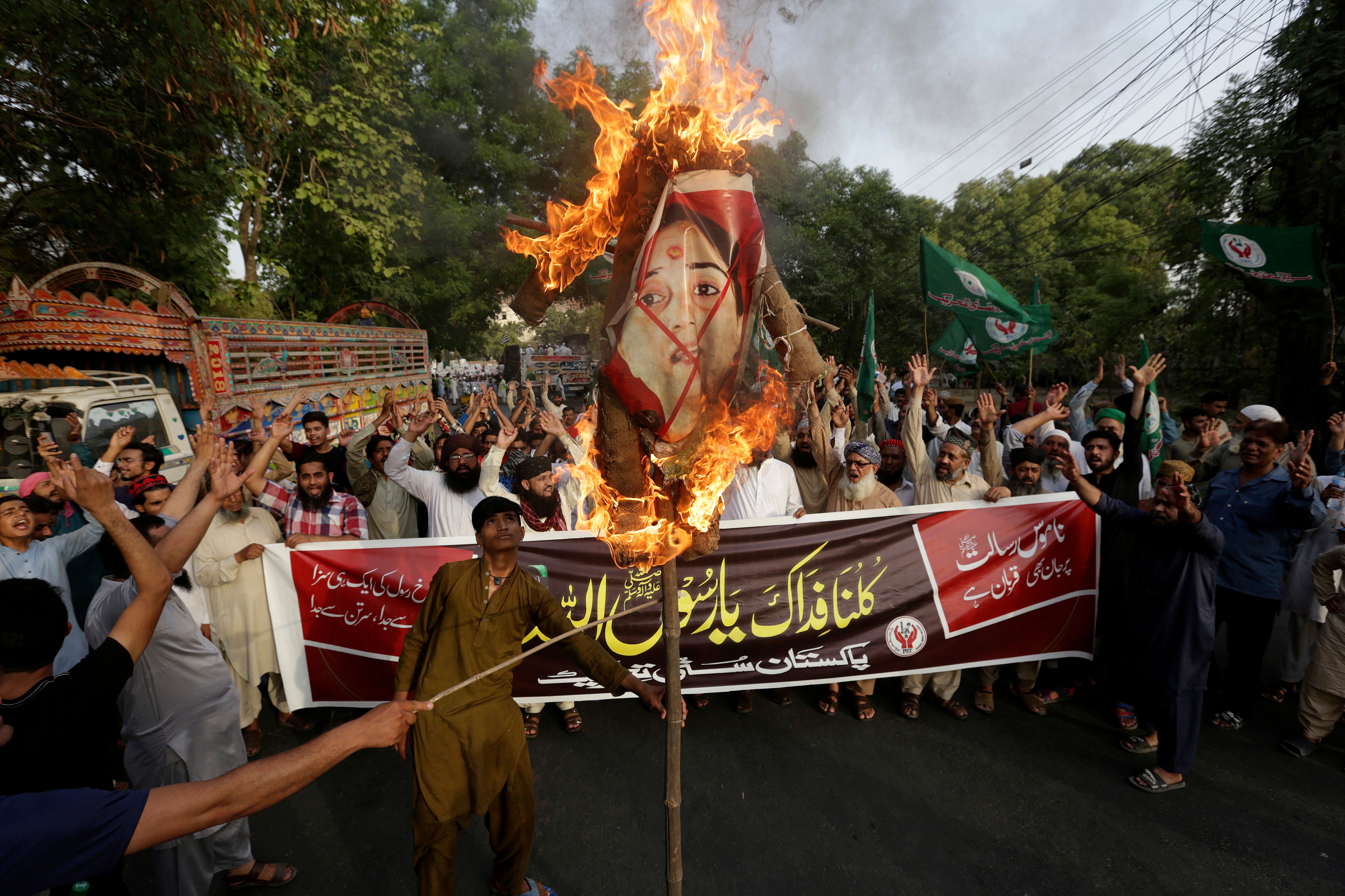 Supporters of a religious group burn a picture of BJP member Nupur Sharma during a demonstration in Lahore, Pakistan, on 12 June to condemn derogatory references to Islam made by her