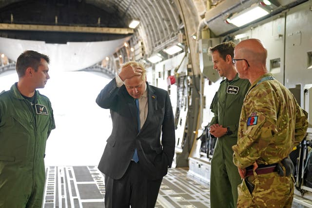 Boris Johnson with aircrew on board a C17, after arriving at RAF Brize Norton following a surprise visit to Kyiv (Joe Giddens/PA)