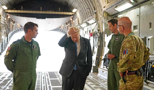 Boris Johnson with aircrew on board a C17, after arriving at RAF Brize Norton following a surprise visit to Kyiv (Joe Giddens/PA)