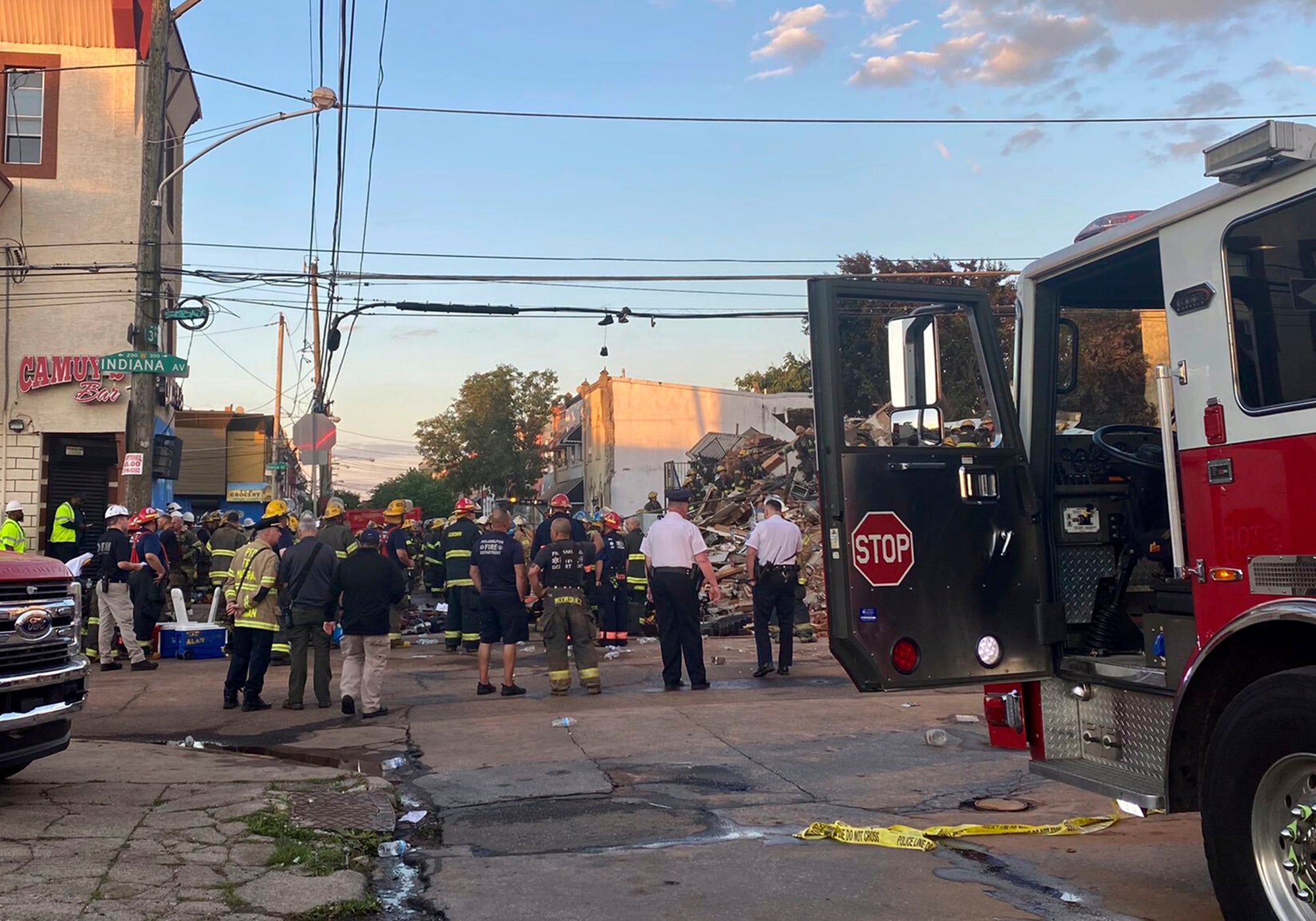 This photo provided by the Philadelphia Fire Dept., emergency personnel respond to the scene of a building that caught fire then collapsed early Saturday, June 18, 2022 in Philadelphia