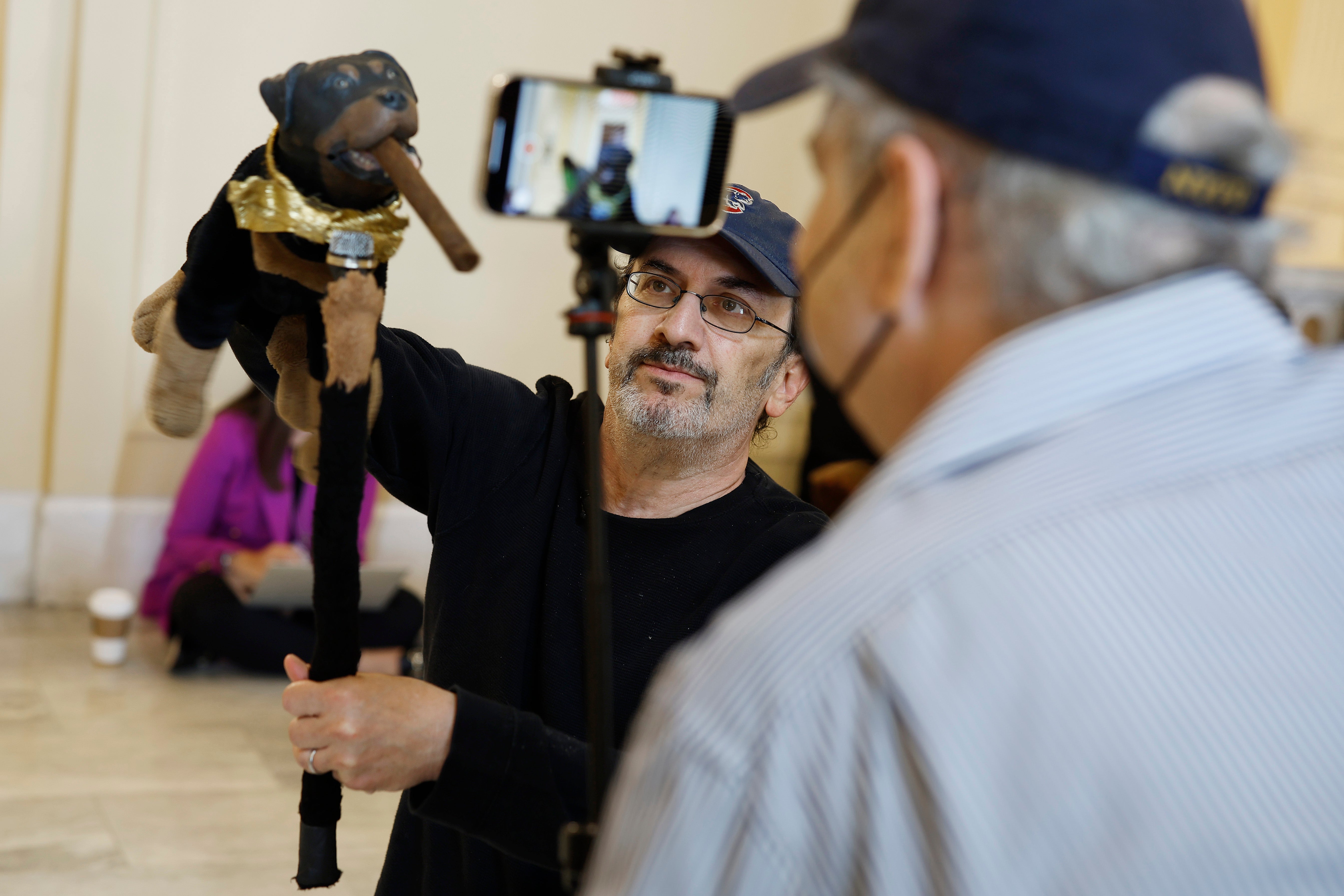 Actor and comedian Robert Smigel performs as Triumph the Insult Comic Dog in the hallways outside the January 6th House select committee hearing
