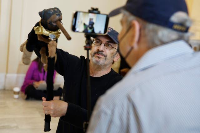 <p>Actor and comedian Robert Smigel performs as Triumph the Insult Comic Dog in the hallways outside the Jan 6 House select committee hearing on 16 June </p>