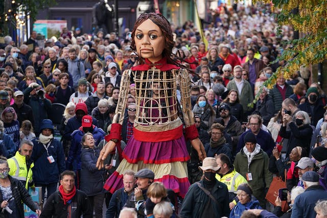 A giant puppet of a 10-year-old Syrian refugee has embarked on a tour of England, visiting landmark destinations to take part in World Refugee Week (PA)