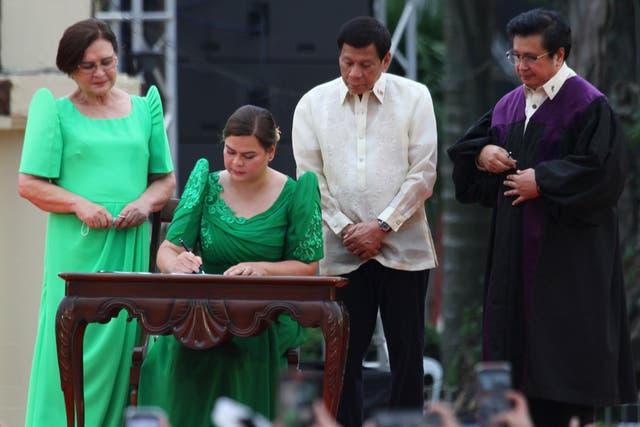 <p>Sara Duterte takes her oath as vice president as her father looks on </p>