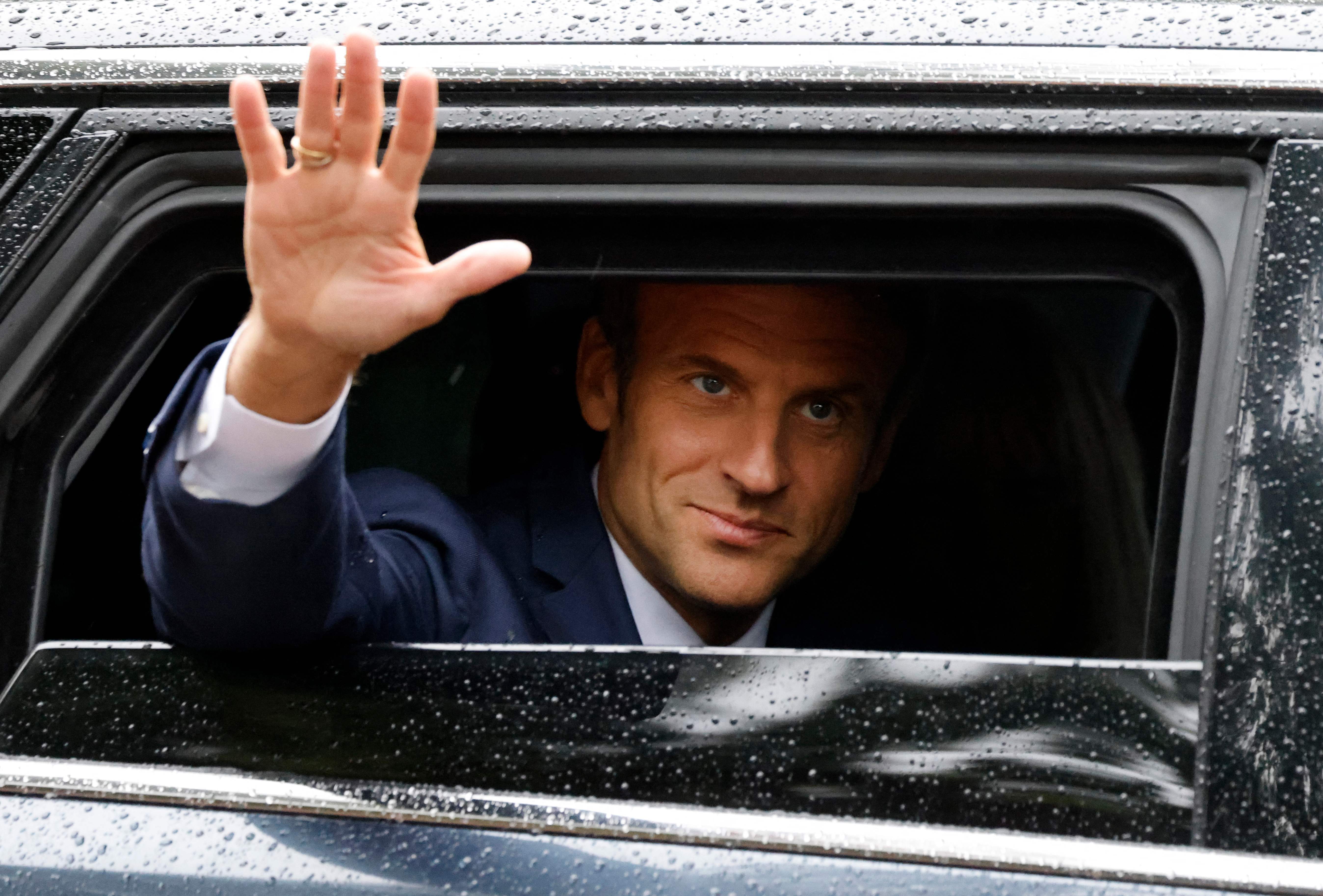 Macron waves to supporters after voting in Le Touquet, northern France