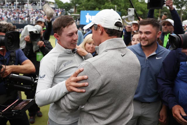 <p>Matt Fitzpatrick is embraced by Rory McIlroy on the 18th green</p>