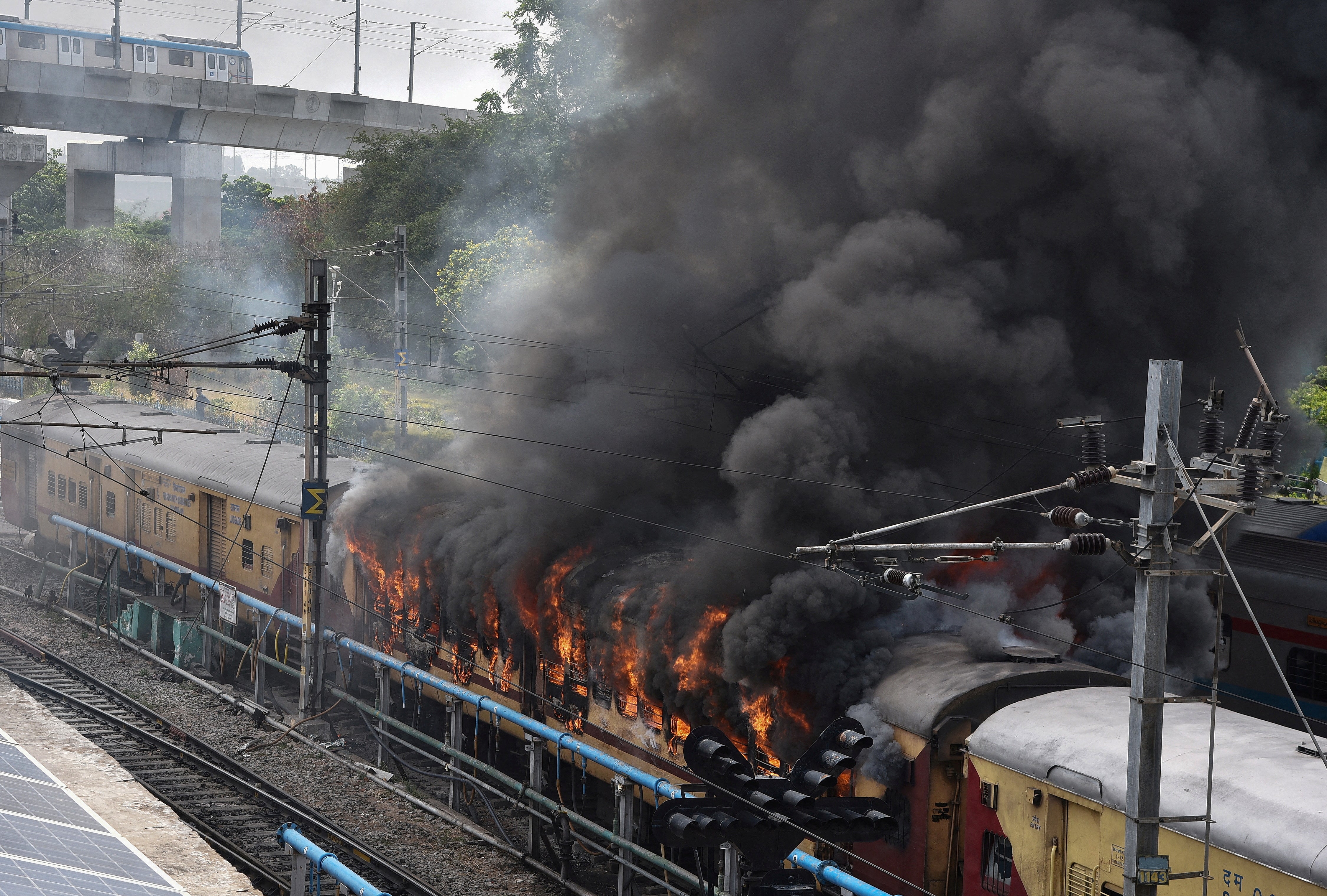 Protesters set fire to a train in protest in the southern state of Telangana