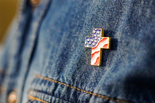 <p>A Christian cross with the American flag </p>