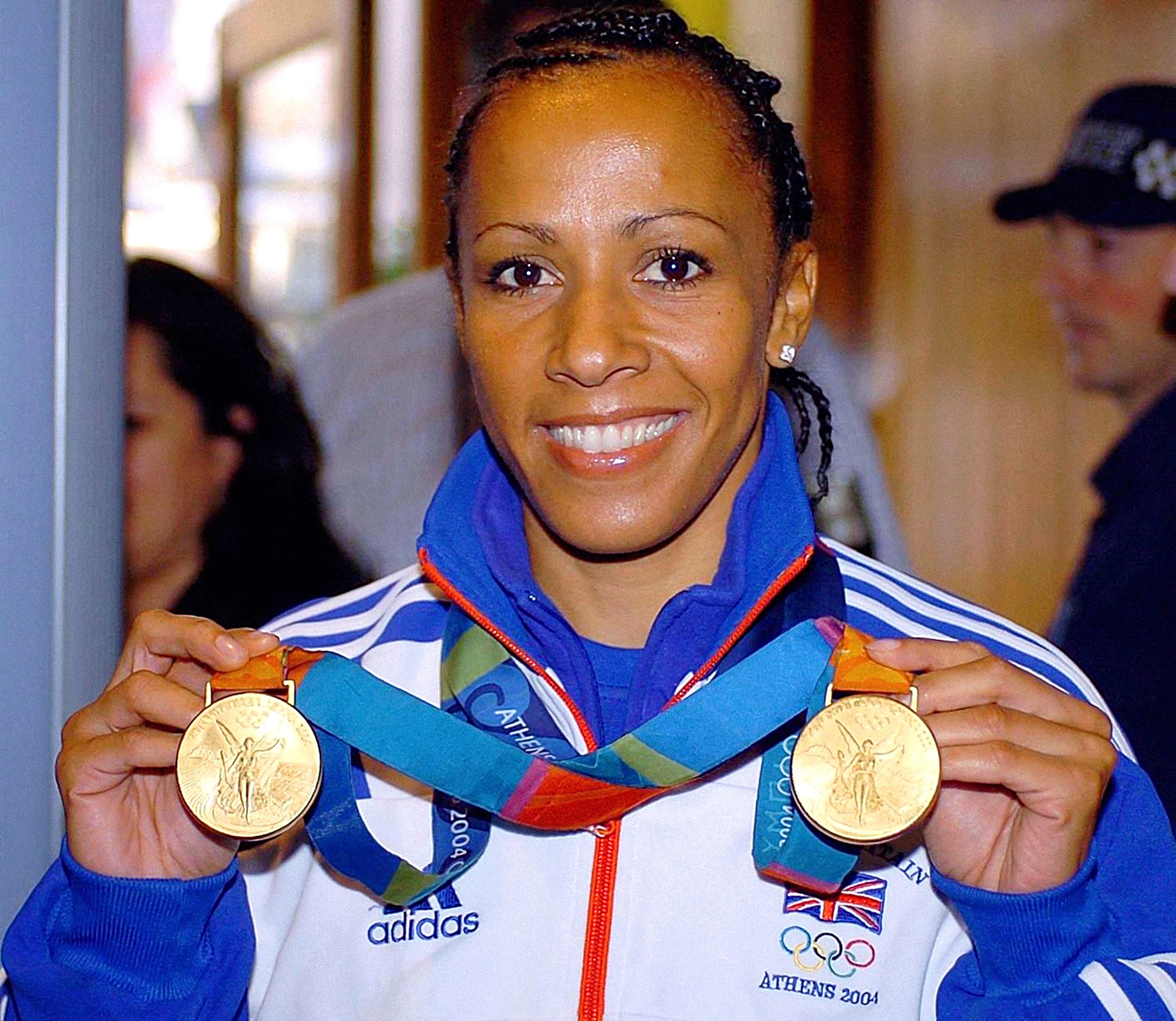 Kelly Holmes shows off her Olympic gold medals from Athens (Rebecca Naden/PA)