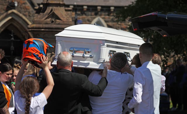 The coffin of Charlie Joyce, nine, is carried into All Saints’ Church in Ballymena (Liam McBurney/PA)