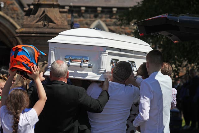 The coffin of Charlie Joyce, nine, is carried into All Saints’ Church in Ballymena (Liam McBurney/PA)