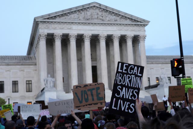 <p>Pro-choice activists protest at the Supreme Court ahead of the landmark <em>Roe v Wade </em>decision </p>