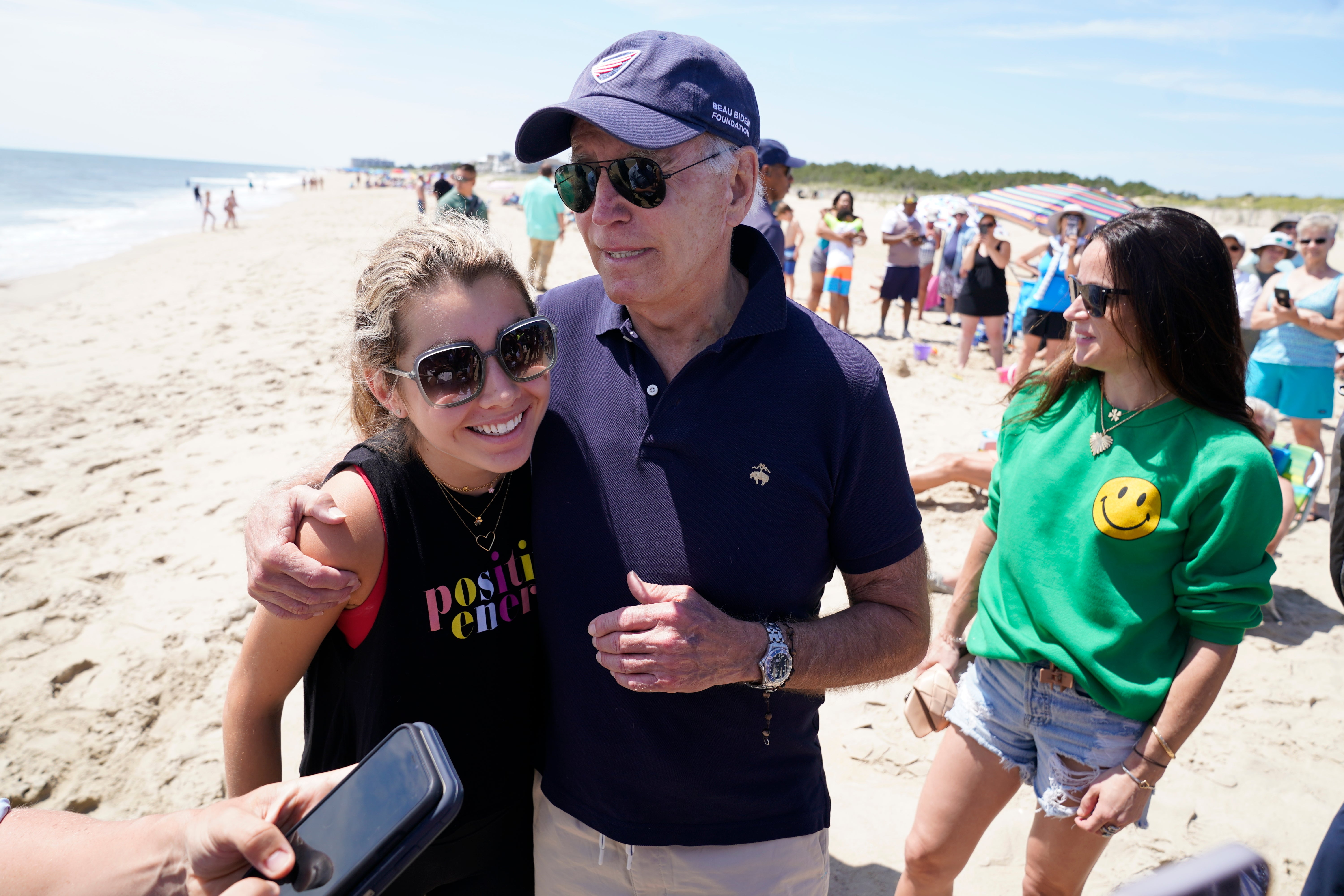 President Joe Biden talks to the media after walking on the beach with his granddaughter Natalie Biden (left) and his daughter Ashley Biden (right) on 20 June 2022 at Rehoboth Beach, Delaware