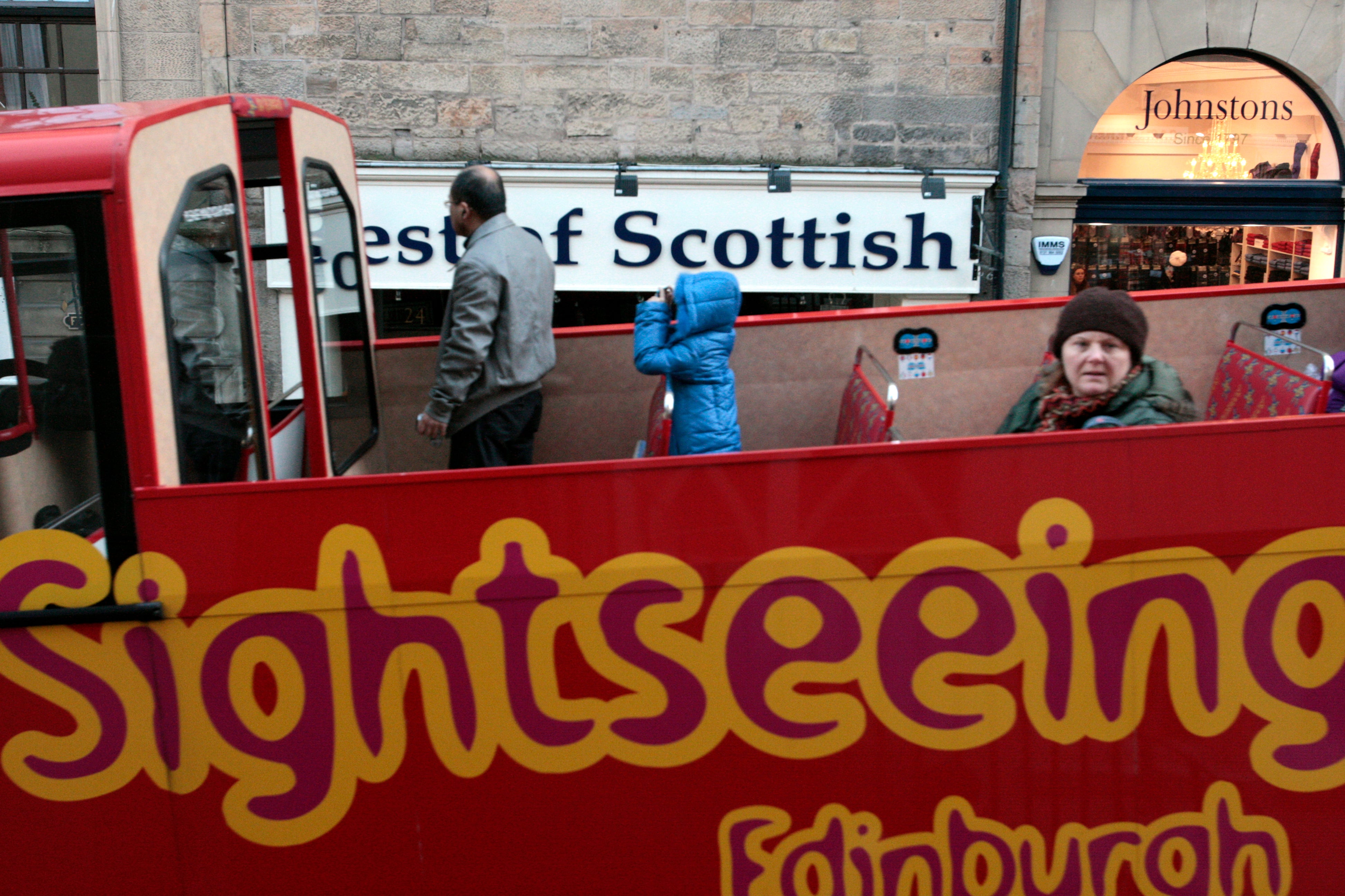 An Edinburgh sightseeing tour bus drives past outside the Scottish Parliament in Edinburgh (David Cheskin/PA)