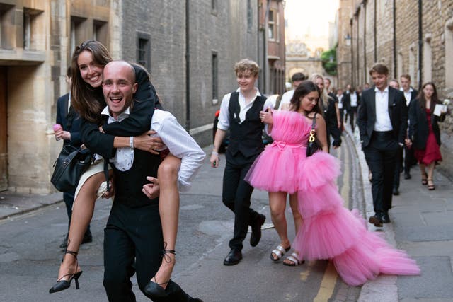 Students from Cambridge University make their way home after celebrating the end of the academic year at a May Ball in Trinity College (Joe Giddens/PA)