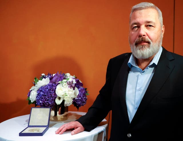 <p>Nobel Peace Prize winner Dmitry Muratov poses with his medal, which he auctioned off to benefit Ukrainian children</p>