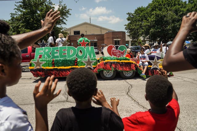 <p>Spectators watch a Juneteenth parade commemorating the end of slavery in the United States in Galveston, Texas last year </p>