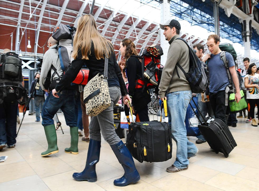 <p>Music fans leaving Paddington Station in London, as they travel down to the Glastonbury Festival in Somerset</p>