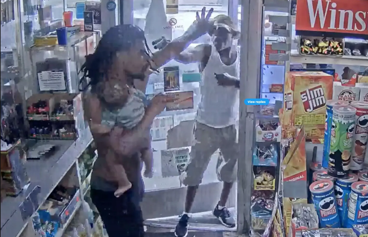 Video shows chilling moment man holding baby is held at gunpoint in Detroit gas station