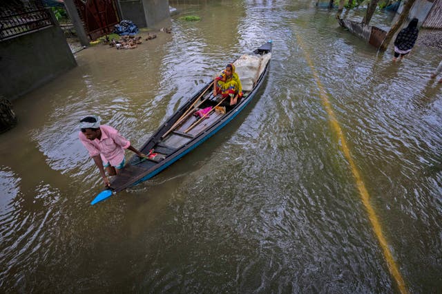 <p>A flood-affected villager rows his boat on a flooded road in Tarabari village, west of Gauhati in northeastern India </p>