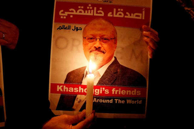 <p>A demonstrator holds a picture of Jamal Khashoggi outside the Saudi Arabian consulate in Istanbul in 2018</p>