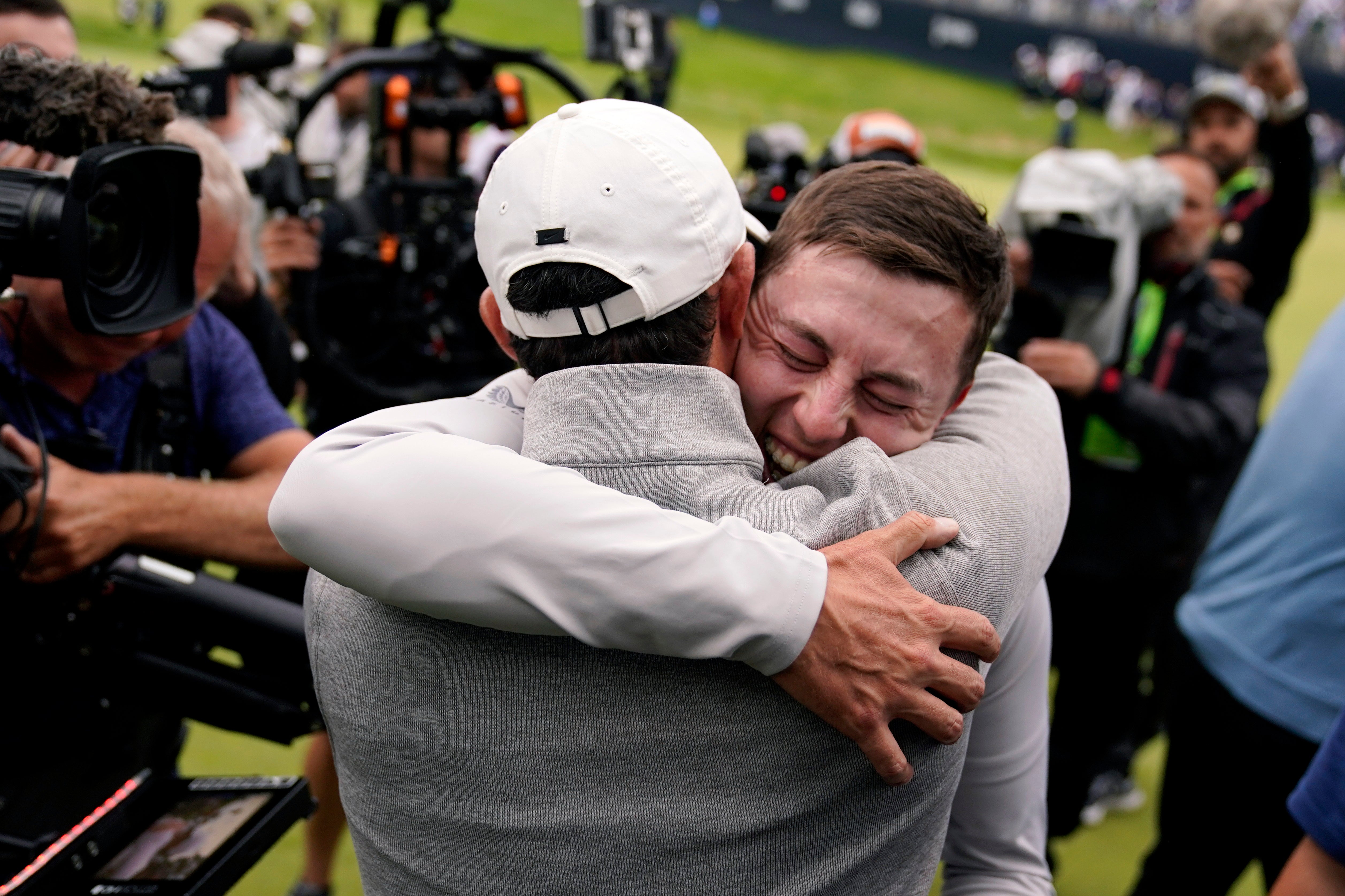 Matthew Fitzpatrick, right, is congratulated by Rory McIlroy after winning the US Open (Charles Krupa/AP)